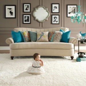 Cute baby sitting on carpet floor | Karen's Advance Floors
