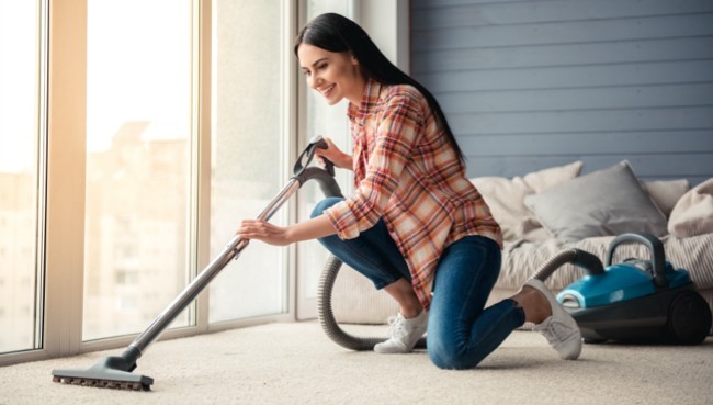 Lady cleaning carpet floor | Karen's Advance Floors