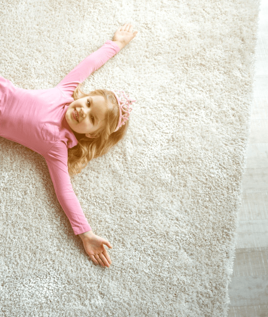 Cute girl laying on rug | Karen's Advance Floors
