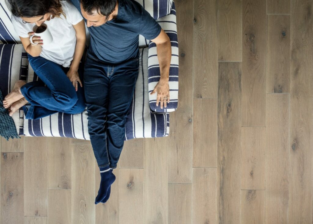 Happy couple sitting on sofa | Karen's Advance Floors